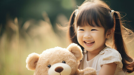 Portrait of a cute Asian girl with a toy