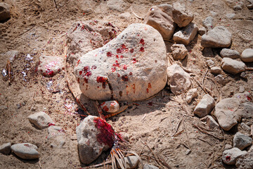 Close up of stains of fresh blood on crushed stone chippings in desert. Murder with the use of...