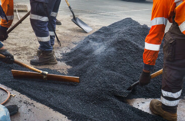 Road resurfacing. Fresh asphalt construction. Workers repairing the road. Auckland.