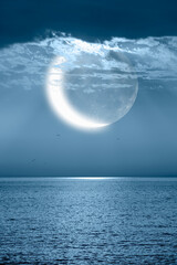 Ramadan concept - Crescent moon over the tropical sea at night "Elements of this image furnished by NASA"