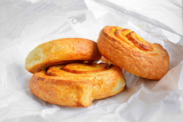 fresh ruddy hot breakfast baking pastries from the bakery in white paper