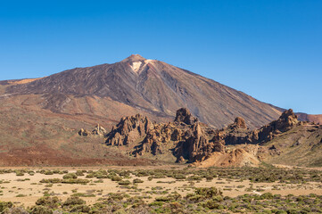 A view of Mount Teide, the volcano in Tenerife, with the geological formations known as Roques de...