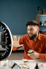 Influencer man blogger talks about skincare. Bearded man recording video blog tells how to be...