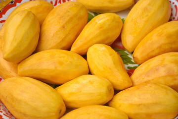 Beautiful yellow mangoes in a tray