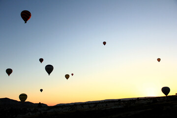 Stunning orange sunrise with silhouette hot air balloons Cappadocia turkey.