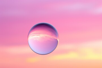 a single bubble floating against a pink sky - Powered by Adobe