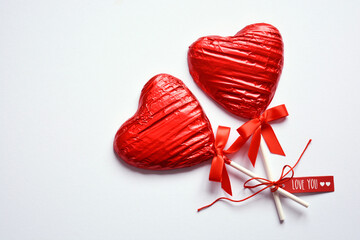 Red heart shaped chocolate candies with I Love You gift tag