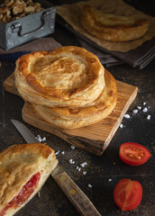 Rustico puff pastry from Lecce filled with stuffed with tomato, mozzarella and bechamel sauce