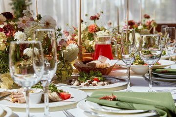 Graceful table setting in the elegant chamber features candles and flowers, their arrangement casting enchanting shadows. The wedding embodies the spirit of Provence