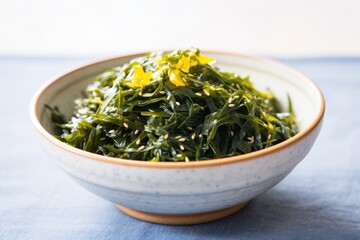 seaweed salad in a blue porcelain bowl on a light grey countertop