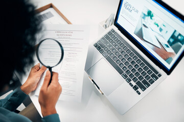 Magnifying glass, computer and woman reading cv in office for company recruitment website. Research, technology and closeup of female designer with hiring paperwork and laptop in workplace. - obrazy, fototapety, plakaty