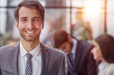 Portrait of casual caucasian male worker looking at camera