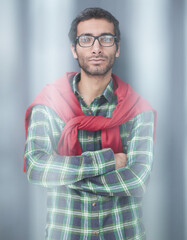 Fototapeta premium Stylish young man posing in the studio on gray background