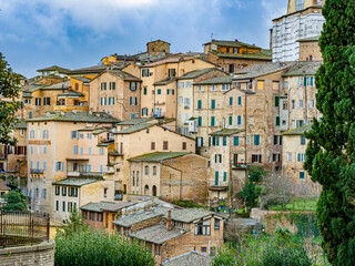 old town in Siena, Italy with historic brick houses, not renovated