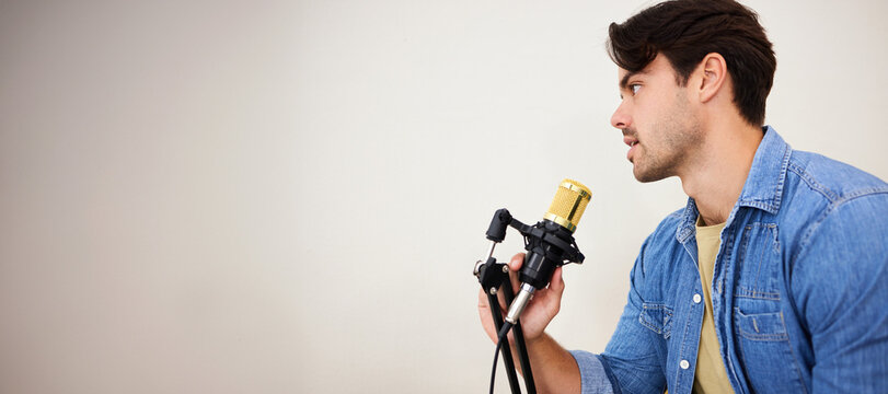 Man, mic and podcast, influencer and media with broadcast, mockup space and communication. Talk show, chat and live streaming with presenter or speaker, interview and platform with wall background