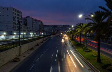 Fototapeta premium Highway in Algiers, Alger, Algeria by night. Long exposure with rays of light coming from the vehicles.