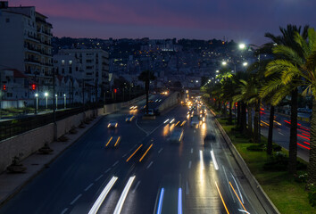 Fototapeta na wymiar Highway in Algiers, Alger, Algeria by night. Long exposure with rays of light coming from the vehicles.