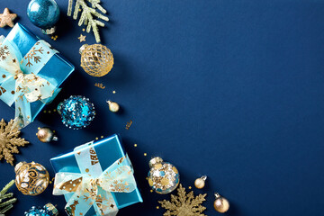 Stylish Christmas card with luxury glistering blue paper gift boxes, gold and blue Xmas balls...