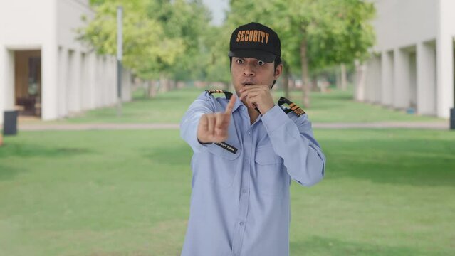 Angry Indian security guard stopping someone by using whistle