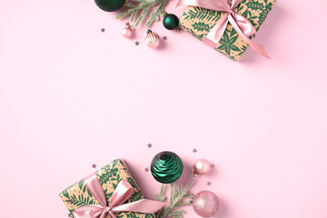 Stylish gift boxes, Christmas balls ornaments, confetti on light pink background. Happy New Year greeting card design, Xmas banner template.