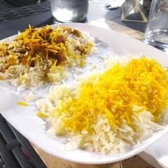 rice on a white plate on the table, Iranian rice with vegetables and spices, Asian rice.