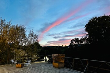 Relaxing corner on a terrace in the mountains under the colorful sunset sky. - 661359250