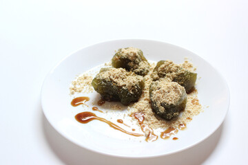 Matcha Warabi Mochi with Kinako powder and brown sugar syrup in white plate on white background, traditional Japanese dessert