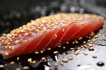 macro shot of sesame seeds on a freshly-cut raw tuna steak