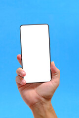 Hand blue background holds smartphone with clean white screen.