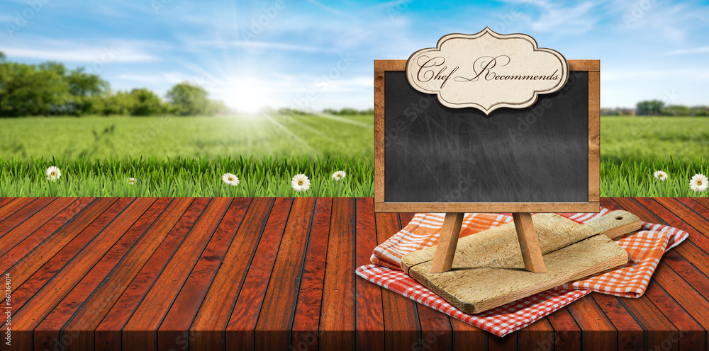 Poster wood cutting board and empty blackboard with copy space and label with text chef recommends on check
