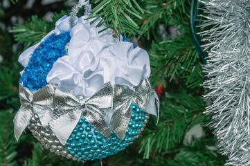 Christmas decoration, blue and white with bows, on the Christmas tree on the eve of the New Year...