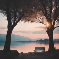 Afwasbaar fotobehang a park bench is sitting next to two trees in front of a body of water © Wirestock