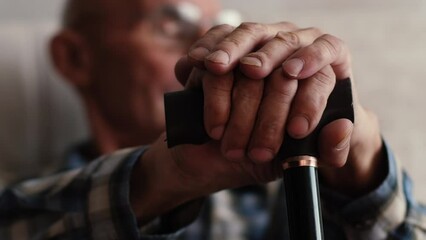 Upset old 70s disabled man sit on couch in retirement house lost in thoughts feeling lonely abandoned, lack communication, sad senior grandfather thinking or mourning at home, elderly solitude concept - Powered by Adobe