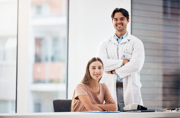 Obraz premium Doctors, man and woman with arms crossed in portrait, smile and hospital office with leadership for medical job. Clinic staff, medic team and happy together for wellness with receptionist at desk