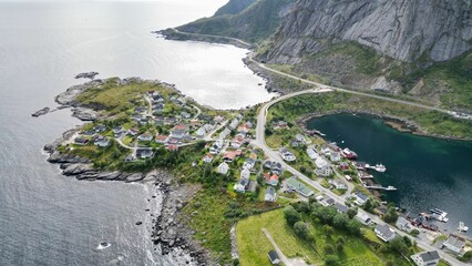 Aerial view of the picturesque village of Lofoten, Norway with vibrant green pastures, and homes