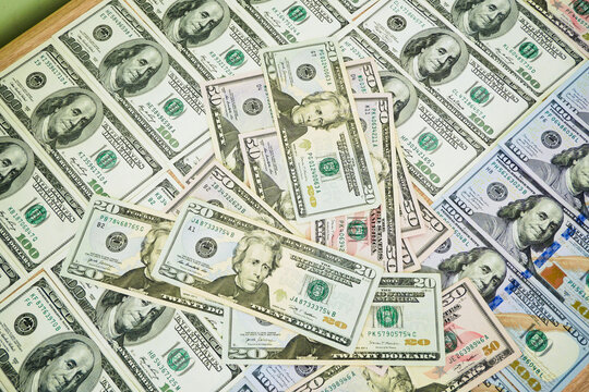 big stack of dollar USA money on wooden background. money cash