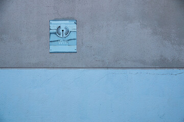 Deteriorated and discolored wifi sign or signal due to sun and inclement weather on a wall