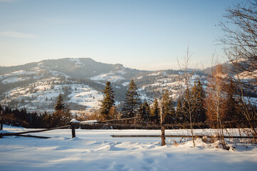 Scenic mountain nature landscape. Carpathian mountains covered with fresh snow. Mountain village.