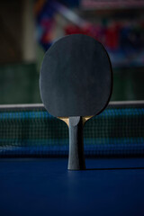 table tennis racket On the blue ping pong table