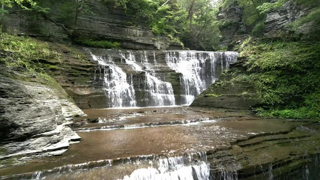 Drone footage over a cascade in Buttermilk Falls State Park in southwest of Ithaca, New York, USA