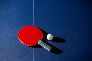 table tennis racket On the blue ping pong table