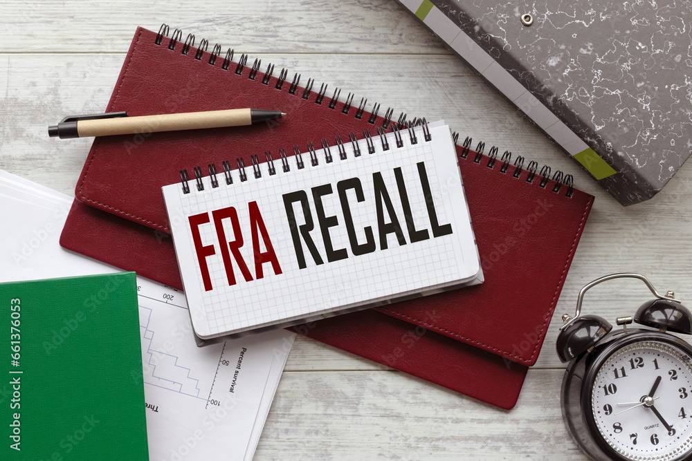 Poster text on a notebook on a diary. a table clock fda recall.
