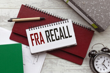 text on a notebook on a diary. a table clock FDA recall.