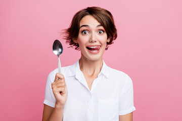 Portrait of funny young girl lick teeth want eat that delicious dessert holding silver spoon...