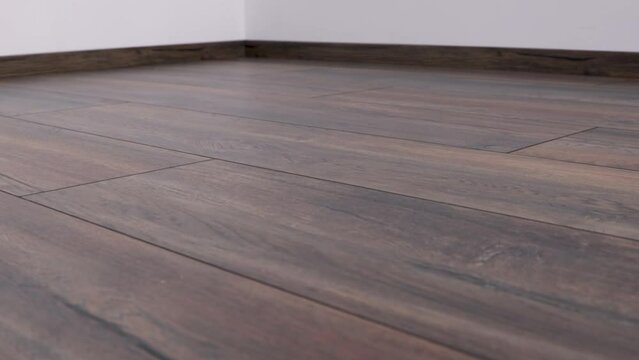 New laminate flooring. Laminated parquet with brown wooden texture