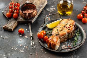 Fried salmon steak with lemon and cherry tomatoes. Concept healthy and balanced eating. place for text, top view