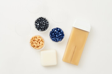 Different types of wax for depilation top view on a white background