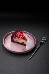 Beautiful tasty sweet slice of cheesecake with cherry on a ceramic plate