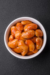 Delicious canned beans in a tomato in a round ceramic plate