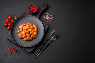 Delicious canned beans in a tomato in a round ceramic plate